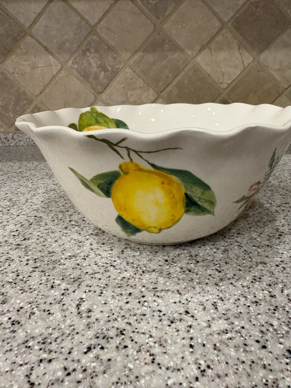 Hand-painted ceramic ruffle bowl featuring lemon motifs. Never Used. Display